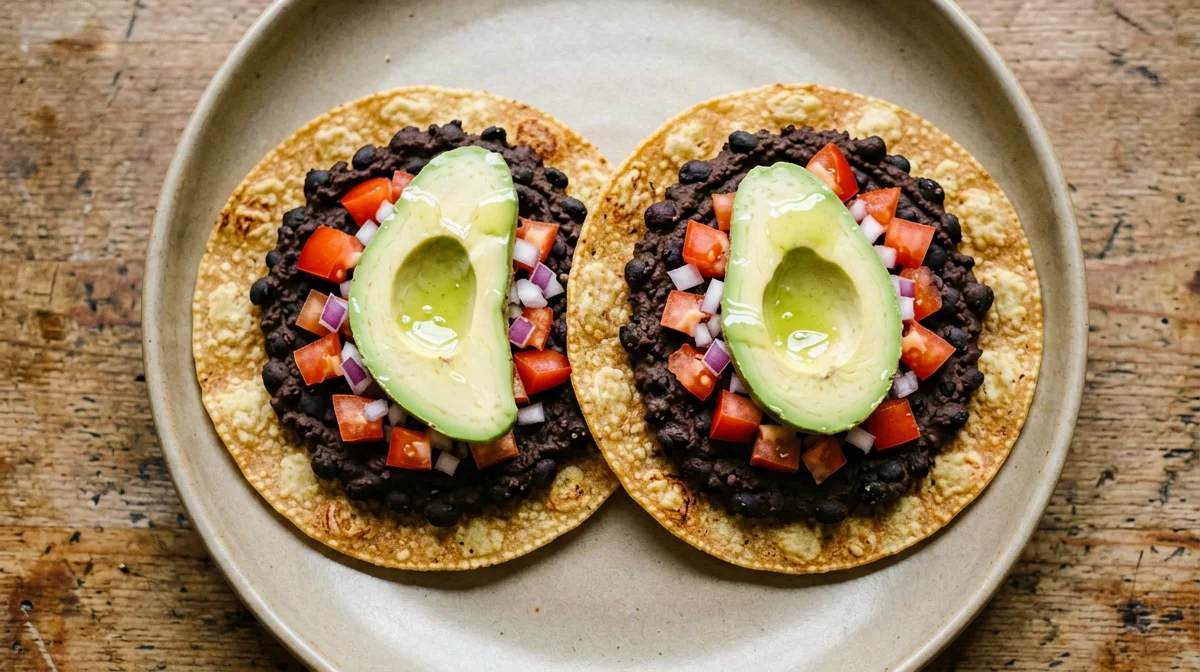 Corn tostada with black beans, tomato and avocado